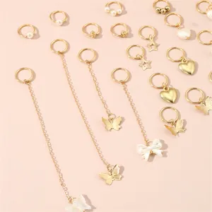 Detail view of gold dreadlock hair rings and cuffs set featuring cute butterflies, hearts and chains.