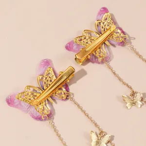 Detail view of vintage mesh butterfly hair clips with elegant long chain charms for women.