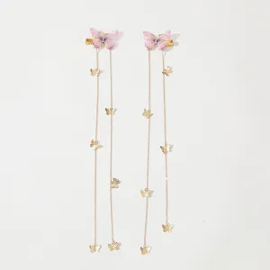 Detailed view of pink mesh butterfly hair clips with long gold chain tassels for women.