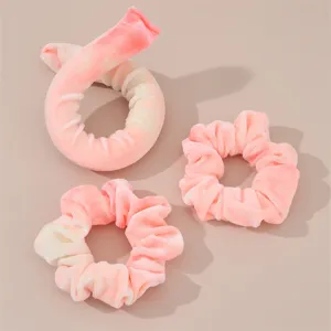 Heatless curling rod headband and scrunchies set in pink tie-dye velvet for soft waves.