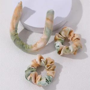 Velvet heatless curling ribbon set with two matching scrunchies in tie dye orange green.