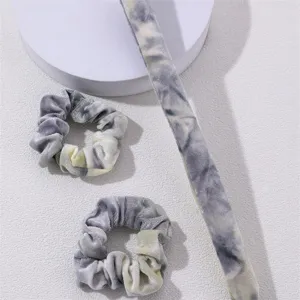 Detail shot of tie-dye velvet hair scrunchies and ribbon set, soft texture and chic style.