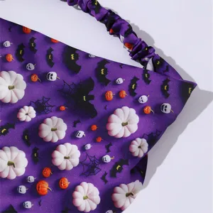 Halloween headband detail view featuring cute pumpkin skull bat print soft purple fabric hair band.