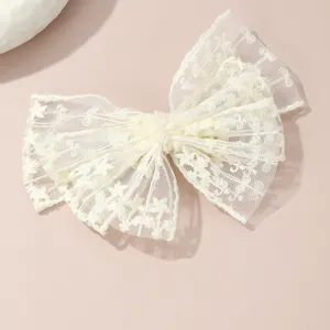 White lace bow hair clip with delicate pearl center, elegant sweet hair accessory detail shot.