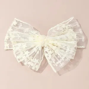 White lace bow hair clip featuring delicate pearl center detail, perfect for elegant summer hair styling.
