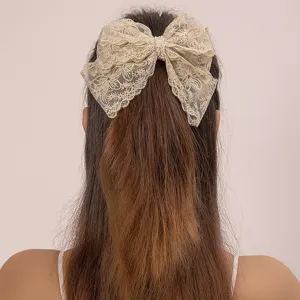 Elegant gold lace hair bow clip with pearl center, perfect for women's daily elegant hairstyles.