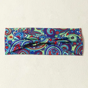 Boho paisley printed fabric headband detail, colorful ethnic twist hair accessory close up.