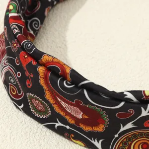 Detail shot of retro ethnic paisley printed fabric headband, showcasing intricate vintage floral patterns.