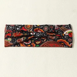 Vintage paisley print twist headband hair accessory detail shot, boho ethnic style fabric.