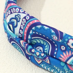 Close-up detail of the blue ethnic paisley printed fabric headband, showing soft texture and patterns.