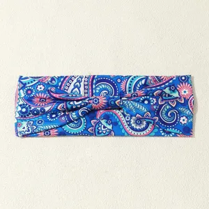 Blue paisley printed fabric headband detail, vintage ethnic hair band accessory close up.