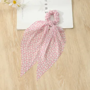 Pink floral print hair scrunchie with long ribbon streamer, sweet style hair accessory detail.