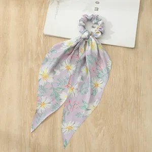 Floral print hair scrunchie with long ribbon scarf, detail view showing soft fabric and cute pattern.
