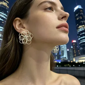 Close-up detail of white woven flower stud earrings featuring an elegant handmade petal design.