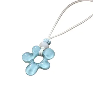 Collier pendentif fleur en résine bleue avec cordon blanc, style de plage bijoux irréguliers.