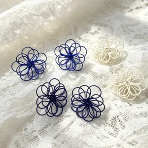 Chic blue and white hollow woven flower earrings, elegant handmade resort style jewelry.