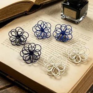 Close-up detail of exquisite metal wire woven flower earrings in blue and white colors.
