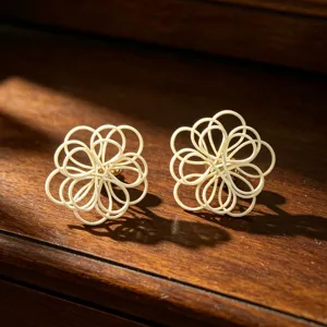 Handmade woven flower stud earrings, elegant hollow floral design, chic resort style accessory.