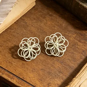 Handmade white wire woven flower stud earrings detailed view, vintage aesthetic jewelry.
