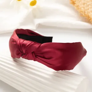 Detailed view of wine red wide knotted satin headband for women, elegant daily hair accessory.