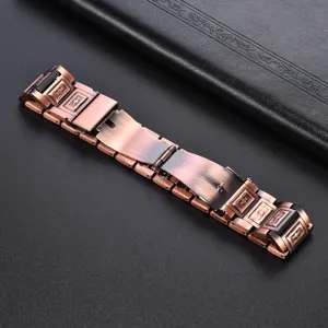 Close-up detail of vintage copper magnetic therapy bracelet links with cross embossed texture.