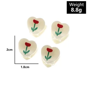 Close-up details of sweet heart-shaped tulip hair claw clips, cute mini hair accessories.