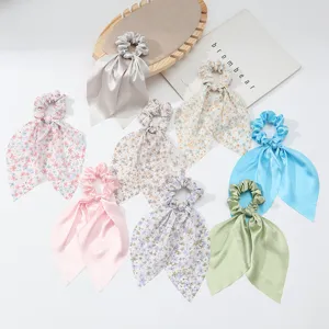 Detailed close-up of trendy French style satin floral ribbon hair scrunchies ponytail holder.