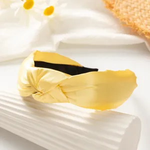 Yellow knotted headband detail shot, wide satin hair hoop for women and girls daily styling.