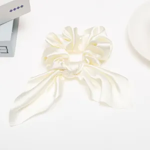 Elegant white satin hair scrunchie with cute streaming ribbon bow for women and girls daily.