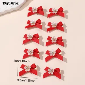 Detail view of red bow hair clips, featuring charming floral rhinestone center, compact 3cm.