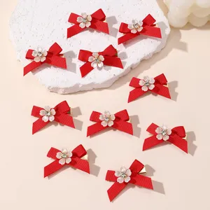 Red bow hair clips set with rhinestone flowers, perfect for New Year styling and daily wear.