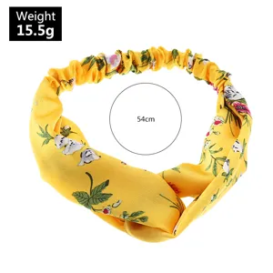 Bandeau en tissu imprime floral jaune style retro avec noeud croise accessoire elegant