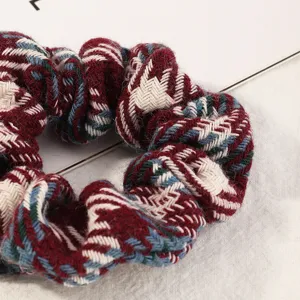 Plaid hair scrunchie for women, soft woolen fabric hair tie, chic ponytail holder accessory.