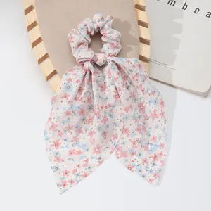 Detailed view of a French style floral hair scrunchie with long ribbon bows for women.