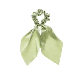 Detailed close-up of light green satin hair scrunchie featuring elegant flowing ribbon ties.