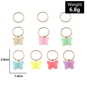 Vue détaillée de bagues de cheveux papillon en résine colorée et accessoires DIY élégants.