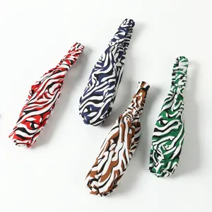 Close-up detail of elastic zebra pattern hair bands, featuring four vibrant color options.