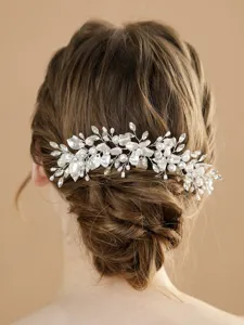 Bridal hair accessory detail featuring silver floral pearls and rhinestones for elegant wedding updo.