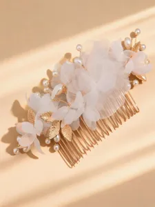 Exquisite gold bridal hair comb detail, featuring white mesh flowers, pearls and leaves.