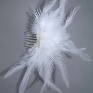 Bridal white feather hair comb handmade elegant wedding party accessory detail shot