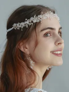 Exquisite crystal flower and pearl bridal headband close-up, elegant hair accessory for women.