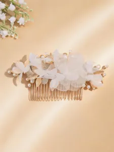 Gold bridal hair comb with white fabric flowers, pearls, and leaf details for wedding.
