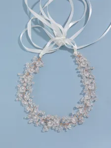 Exquisite bridal pearl crystal hair vine accessory, floral rhinestone wedding headband detail.