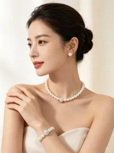 Close-up detail of an elegant imitation pearl necklace and earrings set worn by a graceful model.