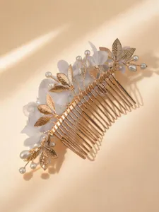 Gold leaf pearl bridal hair comb detail close-up for wedding evening party wear