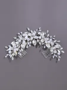 Bridal hair comb with silver leaves, pearls, and crystals for wedding styling and updos.
