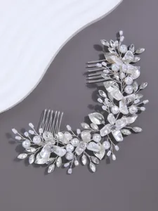 Close-up detail of silver bridal hair comb with pearls and rhinestones for updo style.