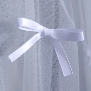 Detailed shot of a Korean white bridal veil featuring a delicate satin bow accent.