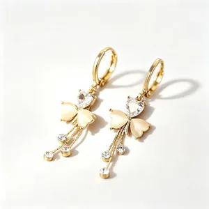 Elegant gold tone clover dangle earrings featuring heart crystal and sparkling rhinestones.