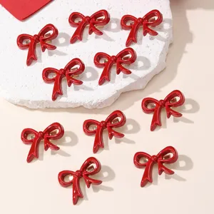 Detailed view of red bow hair clips set, cute glossy duckbill clips for daily hairstyles.